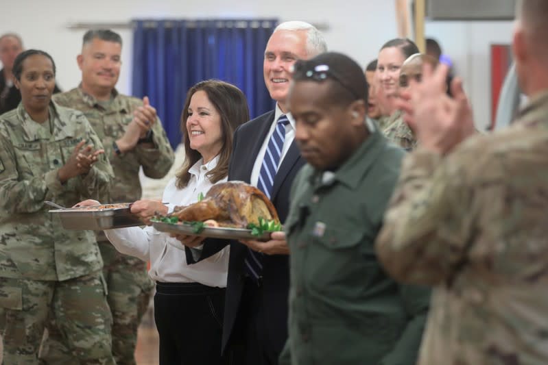 U.S. Vice President Pence and his wife help to serve a Thanksgiving meal to U.S. troops in a dining facility at Camp Flores on Al Asad Air Base, Iraq