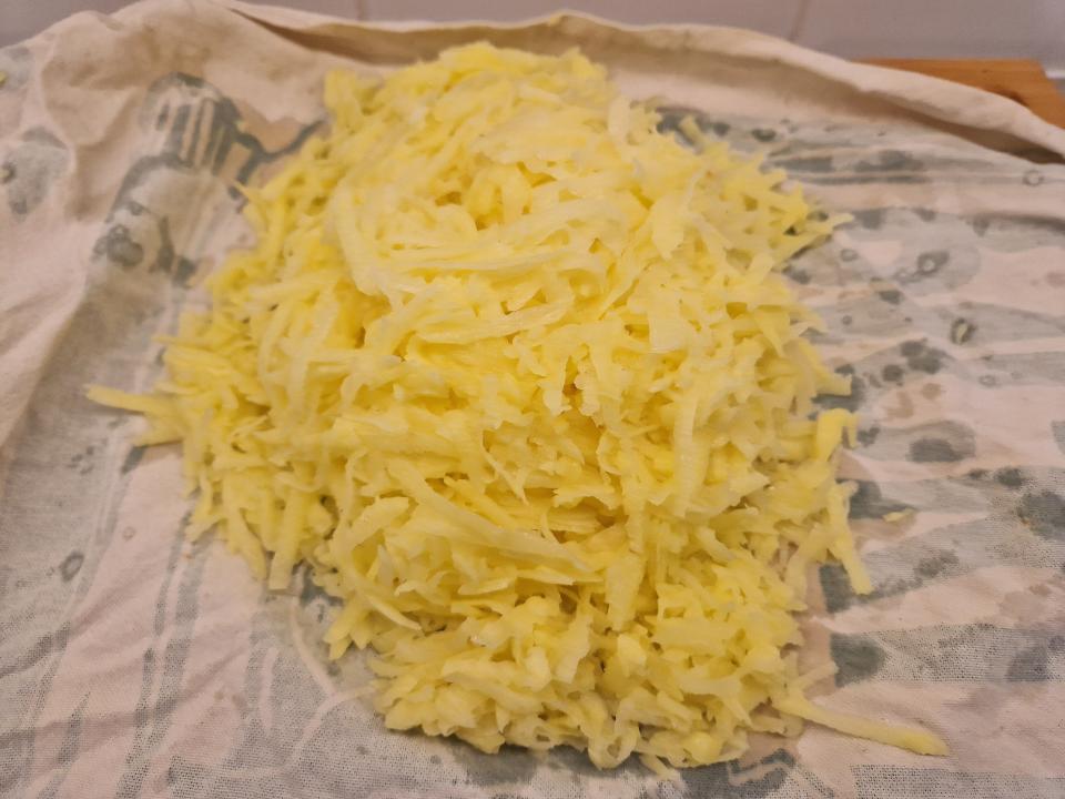 pile of grated potatoes on a tea towel