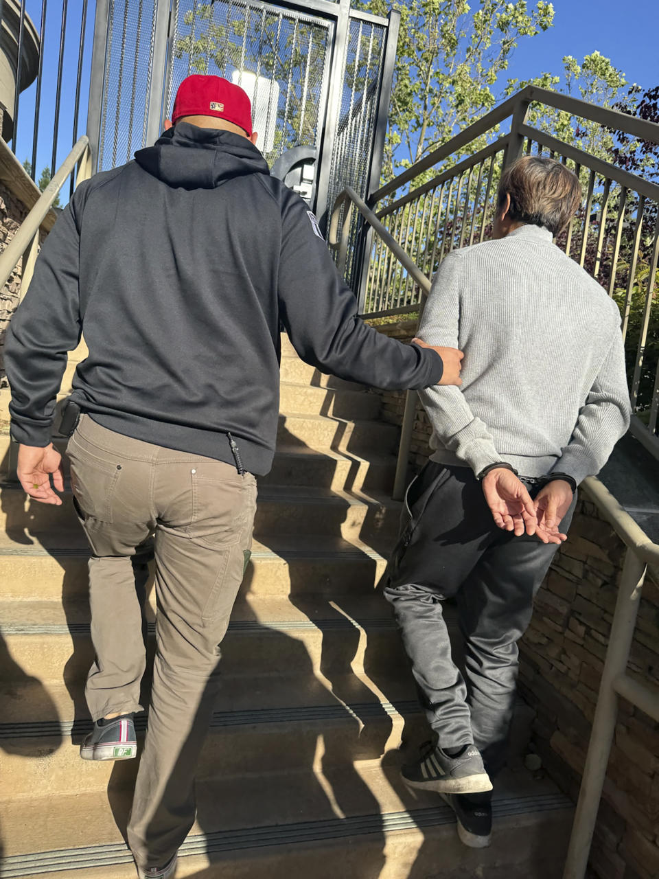 In this photo provided by the U.S. Marshals Service, Tuen Kit Lee is led away in handcuffs on Tuesday, May 28, 2024, in Danville, Calif. The fugitive dubbed the "bad breath rapist" was arrested in the San Francisco Bay Area more than 16 years after he fled following his conviction for sexually assaulting a co-worker in Massachusetts, authorities said this week. (U.S. Marshals Service via AP)