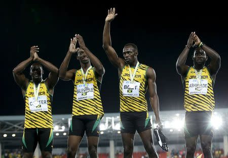 The Jamaican 4x100 meters team celebrate with their silver medals after placing second in the 4x100 meters race at the IAAF World Relays Championships in Nassau, Bahamas May 2, 2015. REUTERS/Mike Segar