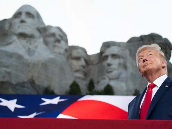 Donald Trump stands in front of Mount Rushmore (AFP via Getty Images)