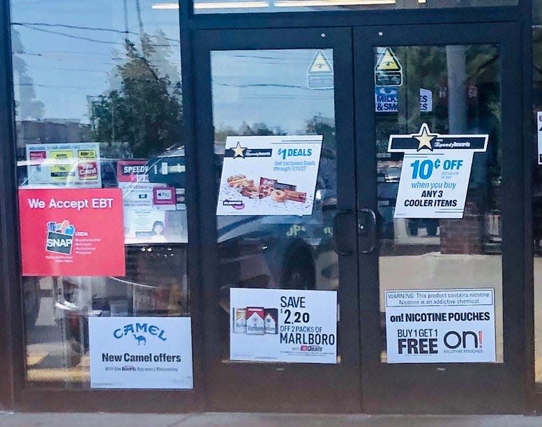 A Milwaukee area storefront with posters advertising cigarettes.