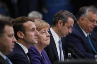 German Chancellor Angela Merkel, center, and French President Emmanuel Macron, second left, participate in a round table meeting at a NATO leaders meeting at The Grove hotel and resort in Watford, Hertfordshire, England, Wednesday, Dec. 4, 2019. As NATO leaders meet and show that the world's biggest security alliance is adapting to modern threats, NATO Secretary-General Jens Stoltenberg is refusing to concede that the future of the 29-member alliance is under a cloud. (AP Photo/Frank Augstein)