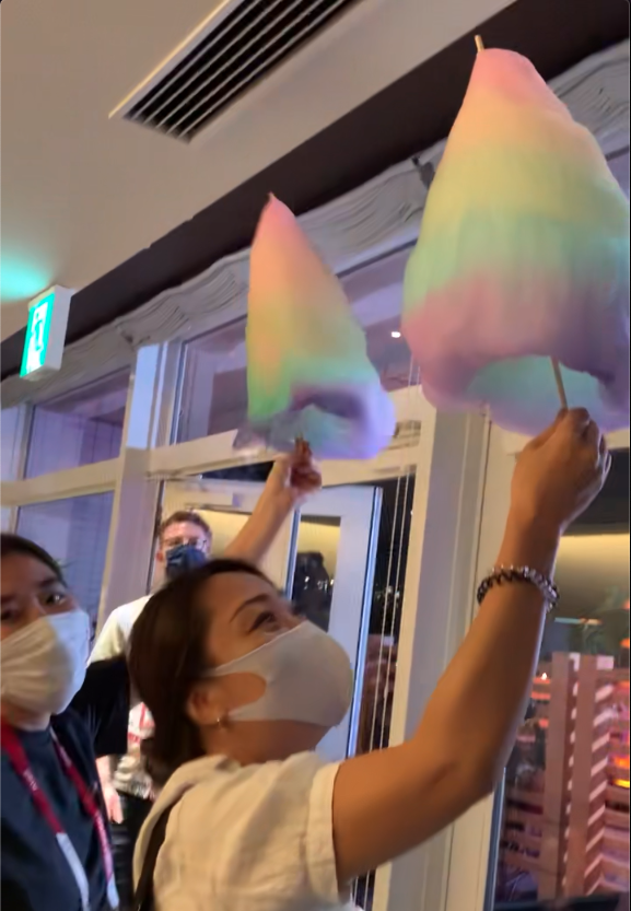 TODAY staffers hold the rainbow cotton candy close to the AC to prevent it from melting. (Kylie Haoues / TODAY)