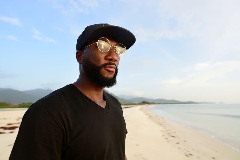 Sierra Leonean musician Emmerson Bockarie watches the sunset on a beach on the outskirts of Freetown,