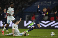 PSG's Kylian Mbappe is challenged during the French League One soccer match between Paris Saint-Germain and Le Havre at the Parc des Princes in Paris, Saturday, April 27, 2024. (AP Photo/Thibault Camus)