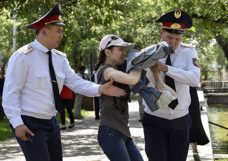 Police officers detain an opposition supporter attempting to stage a protest rally in Almaty, Kazakhstan June 23, 2018. REUTERS/Mariya Gordeyeva