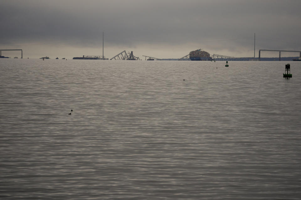 A container ship rests against wreckage of the Francis Scott Key Bridge on Wednesday, March 27, 2024, in Baltimore, Md. The ship rammed into the major bridge early Tuesday, causing it to collapse in a matter of seconds and creating a terrifying scene as several vehicles plunged into the chilly river below. (AP Photo/Matt Rourke)