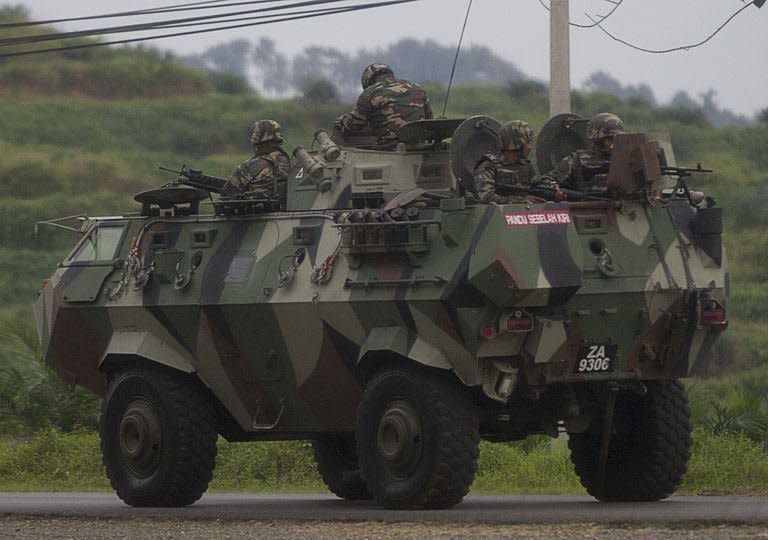 Malaysian soldiers drive towards the area where the stand-off with Sulu gunmen is ongoing, in Tanduo village on March 4, 2013. Malaysia Tuesday launched an attack with jet fighters and soldiers on up to 300 Filipino invaders in a bid to end a bloody three-week standoff in which 27 people had already been reported killed, including eight policemen