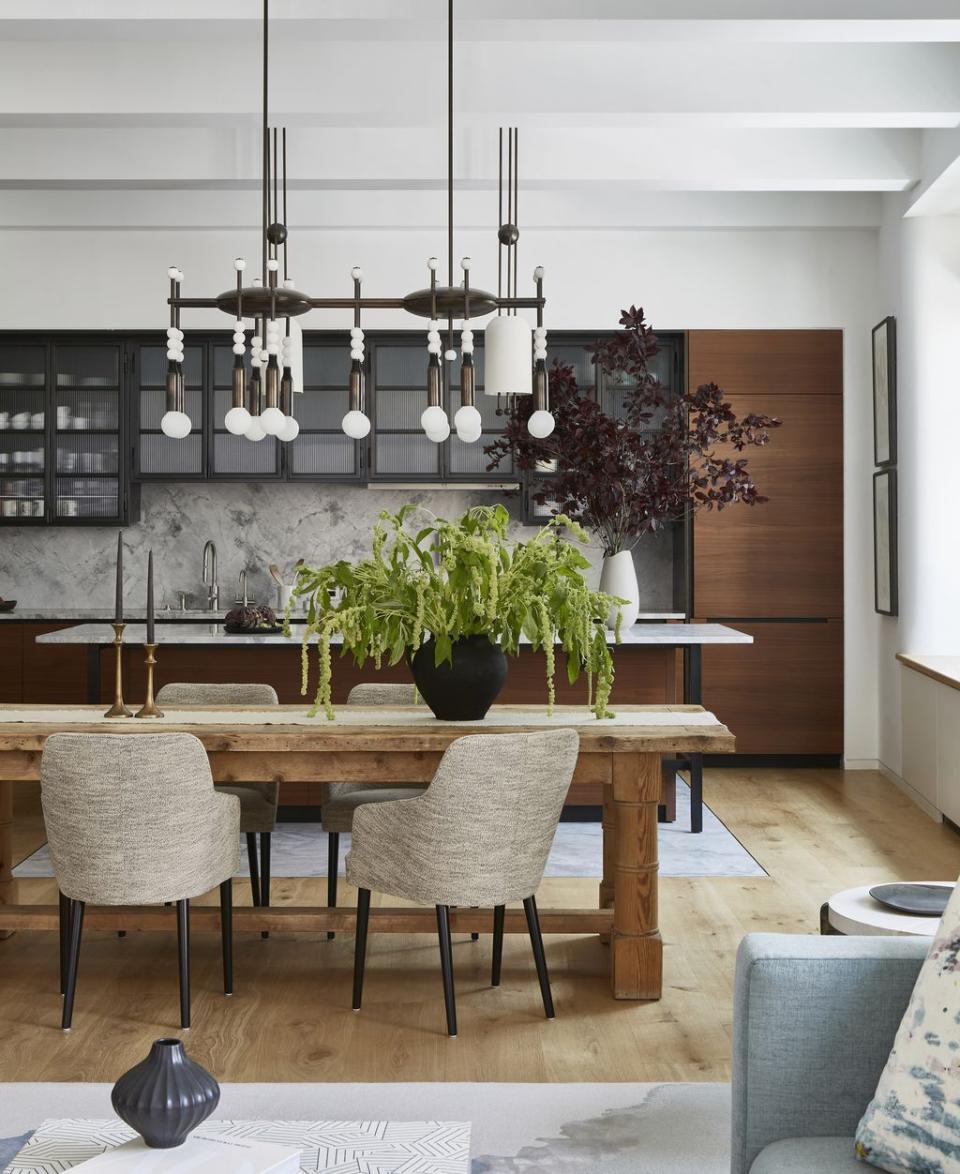 a dining room with a chandelier and chairs