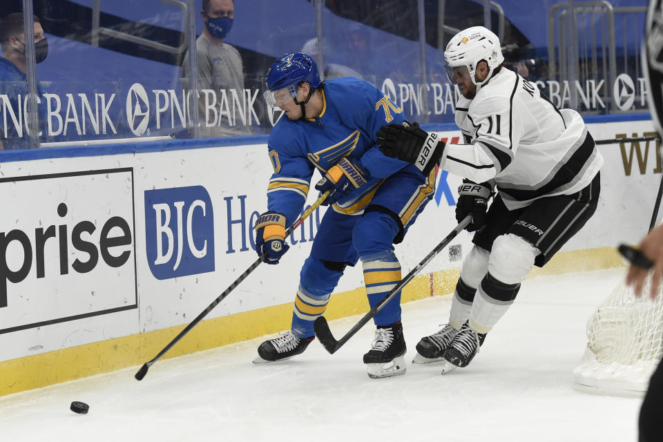 Los Angeles Kings' Anze Kopitar (11) pressures St. Louis Blues' Oskar Sundqvist (70) during the second period of an NHL hockey game Saturday, Jan. 23, 2021, in St. Louis. (AP Photo/Joe Puetz)