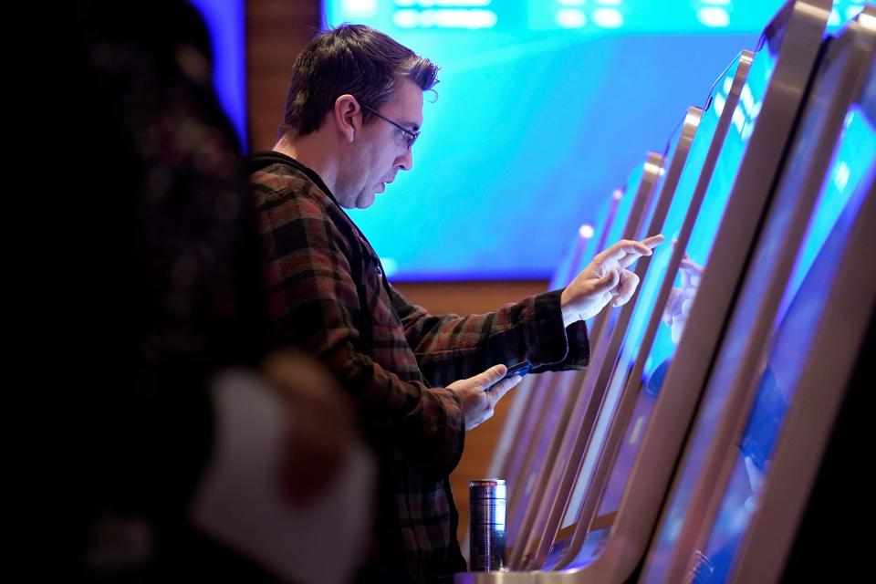 Shawn Harnish of Boston places a sports bet at a kiosk at Encore Boston Harbor casino on Jan. 31. Massachusetts kicked off sports betting at casinos in the state beginning Jan. 31.