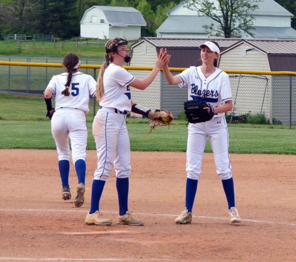 Clear Spring first baseman Faith Moore, right, congratulates pitcher Sarah Greenlee after a strikeout against Smithsburg in the top of fifth inning during their 1A West Region II quarterfinal game. The Blazers defeated the Leopards 16-0.