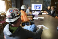 In this March 5, 2020, photo, miners go through a bird identification exercise before they start their shift for Montana Resources in Butte, Montana. The Trump administration is moving to scale back criminal enforcement of a century-old law protecting most American wild bird species. Mark Thompson, the manager of environmental affairs at Montana Resources, said it would keep up the efforts that drive away almost all birds regardless of the Trump administration’s actions, mirroring pledges from some other companies and industries. (Meagan Thompson/The Montana Standard via AP)