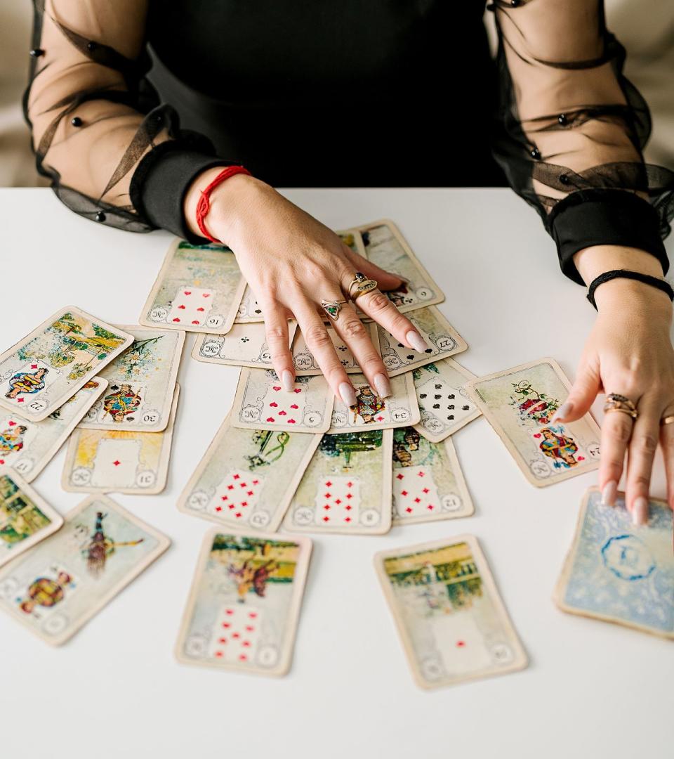 woman fortune teller making predictions, astrologist, tarot cards in hands