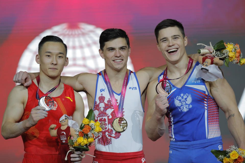 New world champion and gold medallist Russia's Artur Dalaloyan, center, silver medallist China's Xiao Ruoteng, left, and bronze medallist Russia's Nikita Nagornyy, right, pose after the Men's All-Around Final of the Gymnastics World Chamionships at the Aspire Dome in Doha, Qatar, Wednesday, Oct. 31, 2018. (AP Photo/Vadim Ghirda)