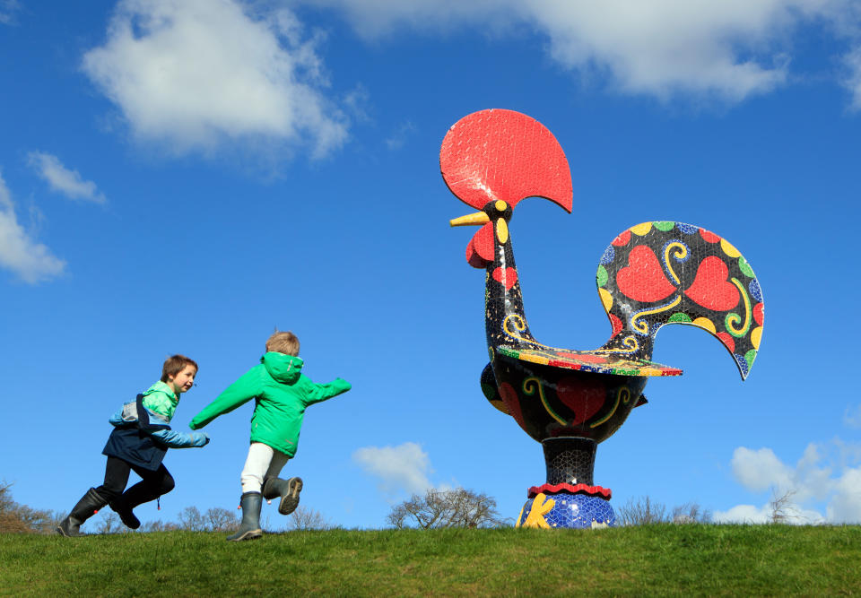 <p>George Thewlis (left) and Benjamin Thewlis play near a work titled 'Pop Galo' by artist Joana Vasconcelosat at Yorkshire Sculpture Park (YSP). The grounds of the park are open and the YSP is looking forward to welcoming visitors back to other areas as soon as government restrictions allow. Picture date: Tuesday April 6, 2021.</p>
