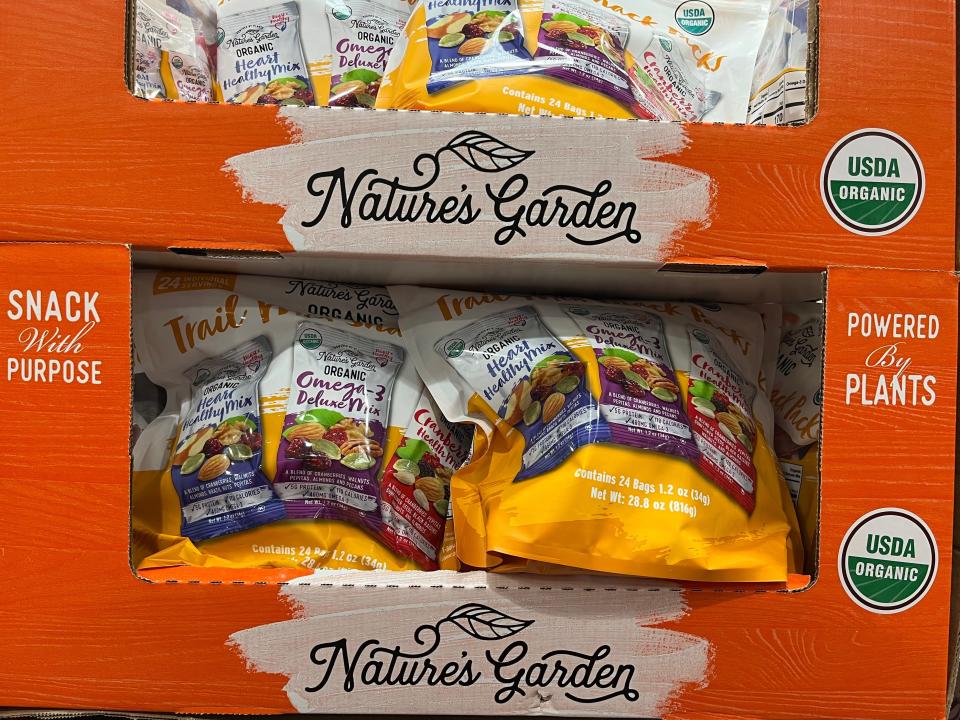 White and yellow Bags of trailmix in orange boxes at Costco