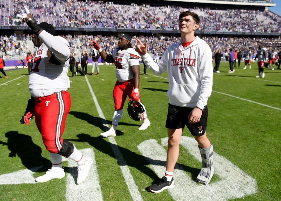 Texas Tech's quarterback Behren Morton (2), right, walks off the field in a boot after the team’s loss against TCU, Saturday, Nov. 5, 2022, at Amon G. Carter Stadium in Fort Worth. TCU won, 34-24.