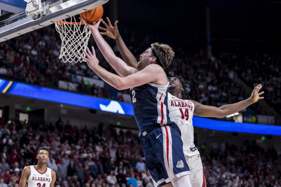 Gonzaga forward Drew Timme (2) gets past Alabama center Charles Bediako (14) for a basket during the second half of an NCAA college basketball game, Saturday, Dec. 17, 2022, in Birmingham, Ala. (AP Photo/Vasha Hunt)