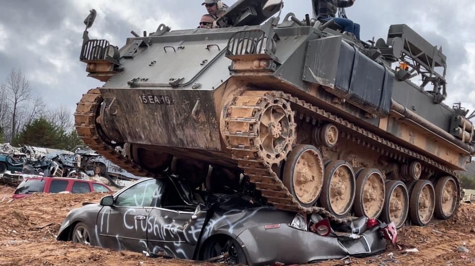 An FV432 armored personnel carrier crushes a car at Tank Town U.S.A. in Morganton, Ga.