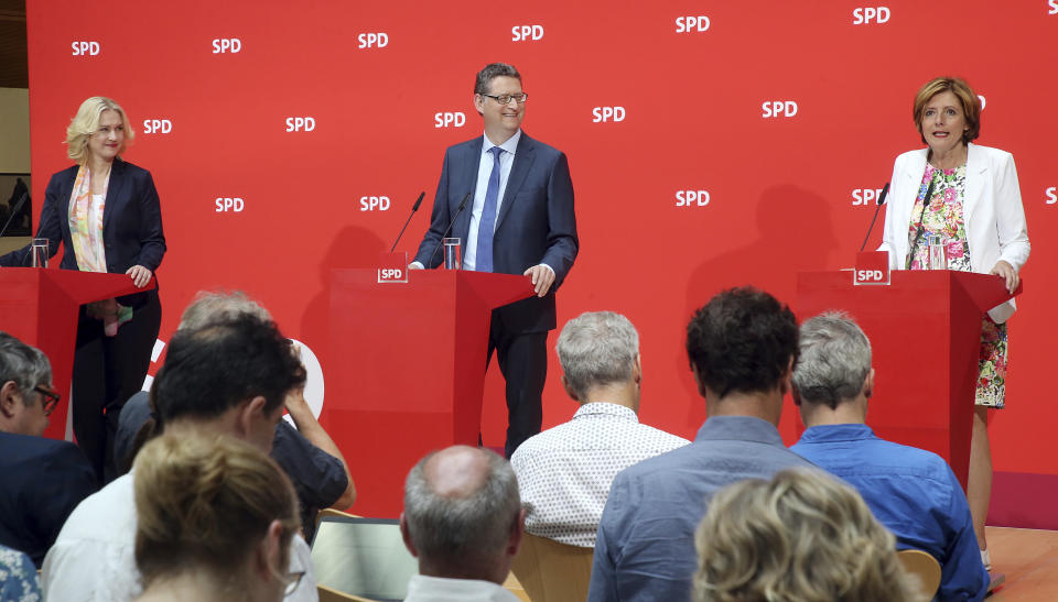 The three interim leaders of German Social Democrats, SPD, Manuela Schwesig, Thorsten Schaefer-Guembel and Malu Dreyer talk to the press in Berlin, Germany, Monday, June 24, 2019. The Social Democrats are in a poll slump and rudderless after leader Andrea Nahles quit following the party's battering in last month's European Parliament election. So far, no one has declared their candidacy for the notoriously difficult job — and the three deputy leaders who have taken the reins jointly on an interim basis have all ruled themselves out. (Wolfgang Kumm/dpa via AP)