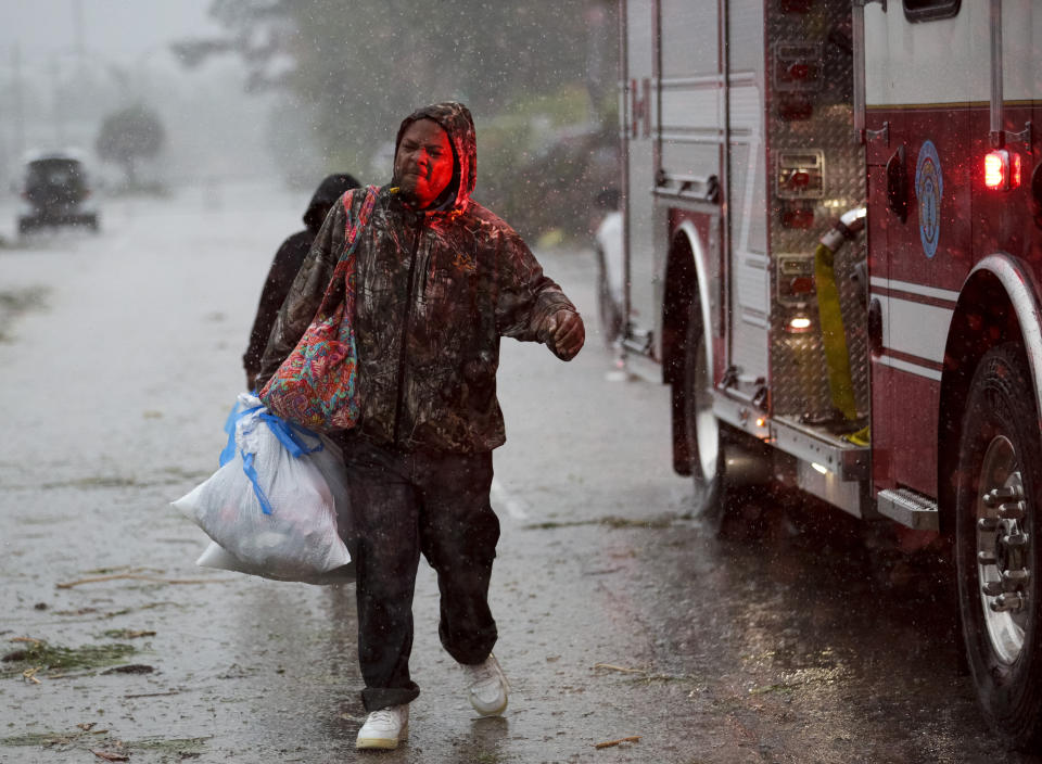 Antonio James carries a bag of dry clothes and belongings with him after his house was damaged by an apparent tornado in south Slidell, La., Wednesday, April 10, 2024. (Scott Threlkeld/The Times-Picayune/The New Orleans Advocate via AP)