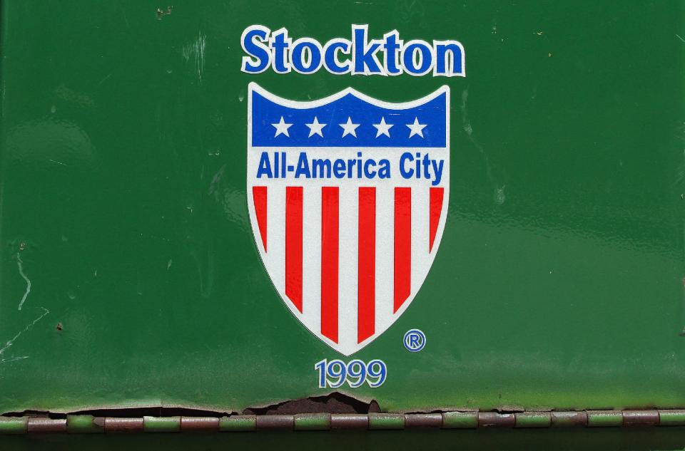 A payment drop box near city hall sports the Stockton All-America City logo Tuesday, June 26, 2012, in Stockton, Calif. Stockton officials continue to grapple with the city's financial plight, struggling to restructure millions of dollars of debt threatening to turn the city with the nation's second highest foreclosure rate into the largest American city to file for bankruptcy. (AP Photo/Ben Margot)