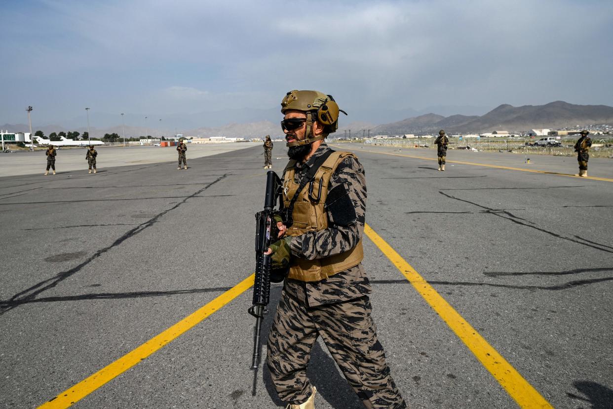 TOPSHOT - Members of the Taliban Badri 313 military unit walks at the tarmac as they secure the airport premises in Kabul on August 31, 2021 after the US has pulled all its troops out of the country to end a brutal 20-year war -- one that started and ended with the hardline Islamist in power. (Photo by WAKIL KOHSAR / AFP) (Photo by WAKIL KOHSAR/AFP via Getty Images)