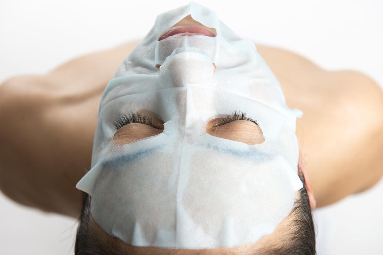 woman lying down with facial mask