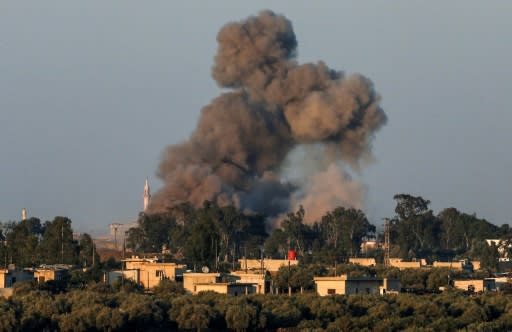 A picture taken on July 23, 2018 from the Israeli-annexed Golan Heights shows a smoke plume rising during air strikes backing a Syrian-government-led offensive in the southwestern province of Daraa