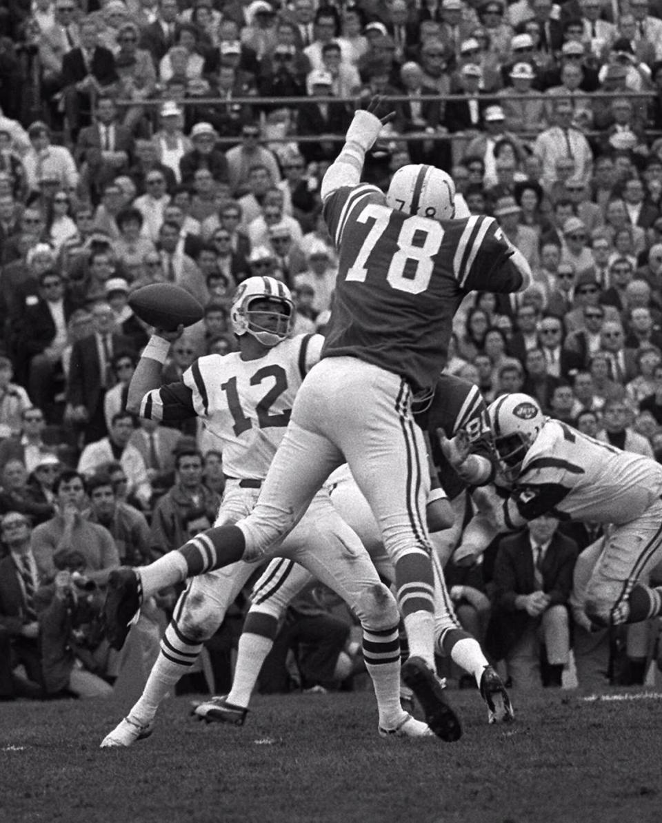 New York Jets quarterback Joe Namath throws over Baltimore Colts’ defensive end Bubba Smith during Super Bowl III, Jan. 12, 1969 at the Orange Bowl.