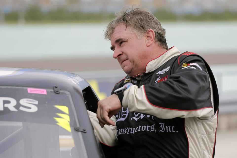 Joe Nemechek gets in his truck before practice for a NASCAR Truck Series auto race on Friday, Nov. 15, 2019, at Homestead-Miami Speedway in Homestead, Fla. Nemechek is expected to start his 1,186th race Friday, breaking Richard Petty's record of 1,185 for the most NASCAR starts. (AP Photo/Terry Renna)