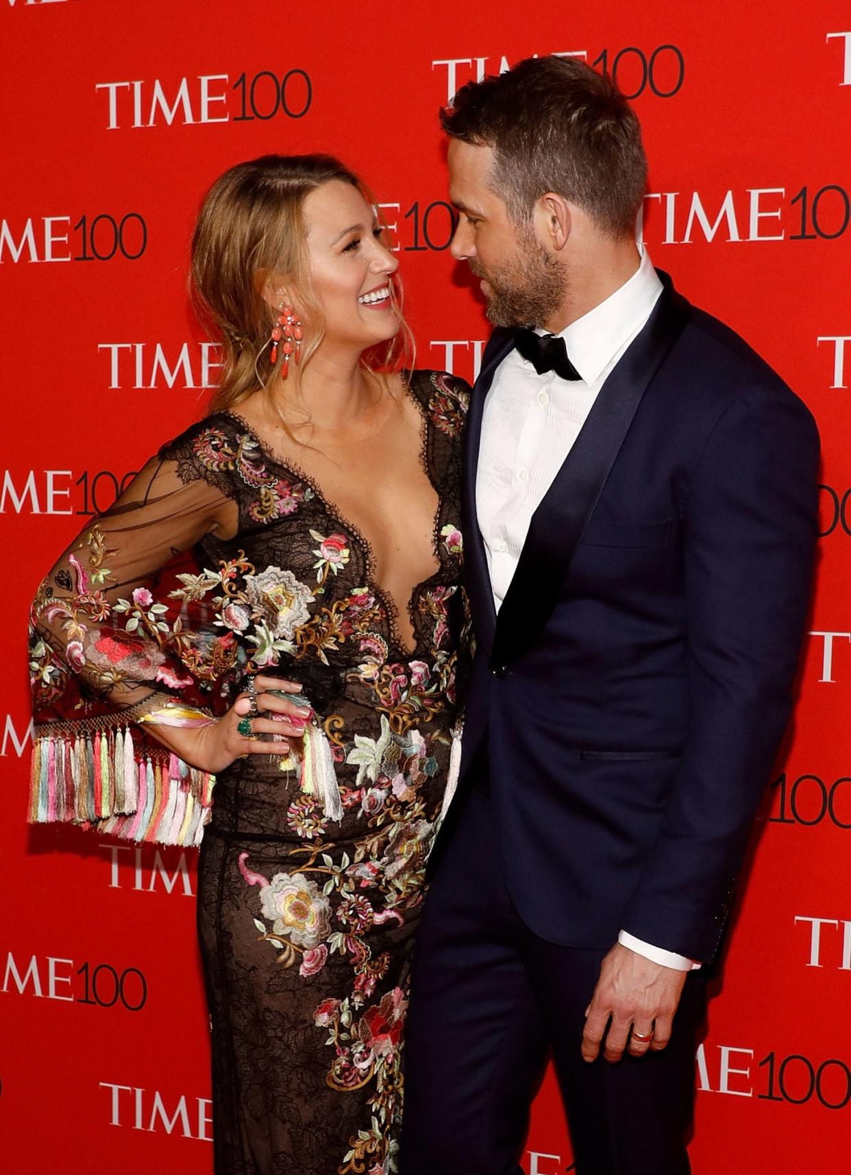 Blake Lively and Ryan Reynolds at an event looking at each other