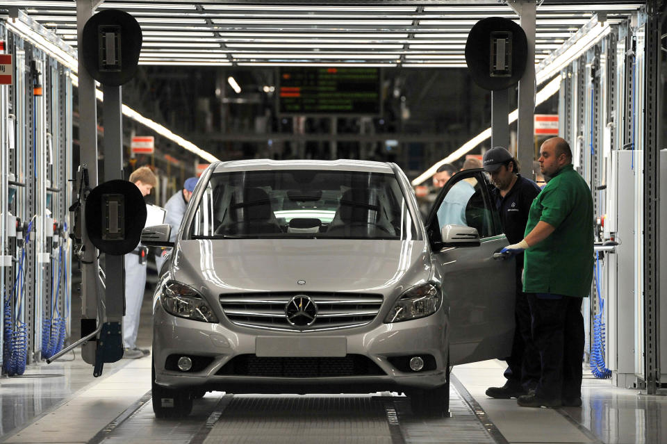 Worker check the assembled cars in the assembly hall in the new Mercedes plant in Kecskemet, 83 kms southeast of Budapest, Hungary, prior to the the official inauguration ceremony of the Kecskemet Mercedes factory on Thursday, 29 March, 2012. The new Mercedes plant built on a basic territory of 441 hectares with an investment of 800 million euros has a yearly capacity of 100,000 cars of two types of compact B-Class produced by 2,500 employees. (AP Photo/MTI, Tamas Kovacs)