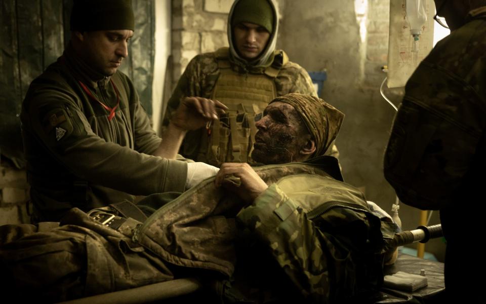 Military medics work on a member of the Ukrainian military suffering from head and leg injuries caused by a mine outside Bakhmut - Getty Images Europe