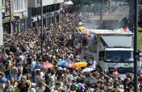 Participants of the Cologne Pride rally march through the city center in Cologne, Germany, Sunday, July 3, 2022. This year's Christopher Street Day (CSD) Gay Parade with thousands of demonstrators for LGBTQ rights is the first after the coronavirus pandemic to be followed by hundreds of thousands of spectators in the streets of Cologne. (AP Photo/Martin Meissner)