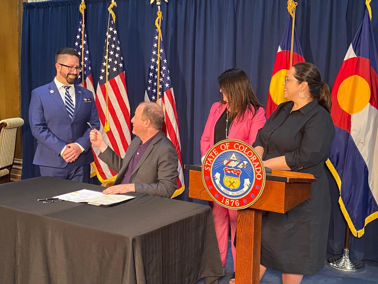 From left to right, Colorado Rep. Matt Martinez, Gov. Jared Polis, Rep. Rose Pugliese and Sen. Julie Gonzales are pictured during Polis' signing of Colorado HB 23-1037, "Department of Corrections Earned Time For College Program Completion," on April 12.