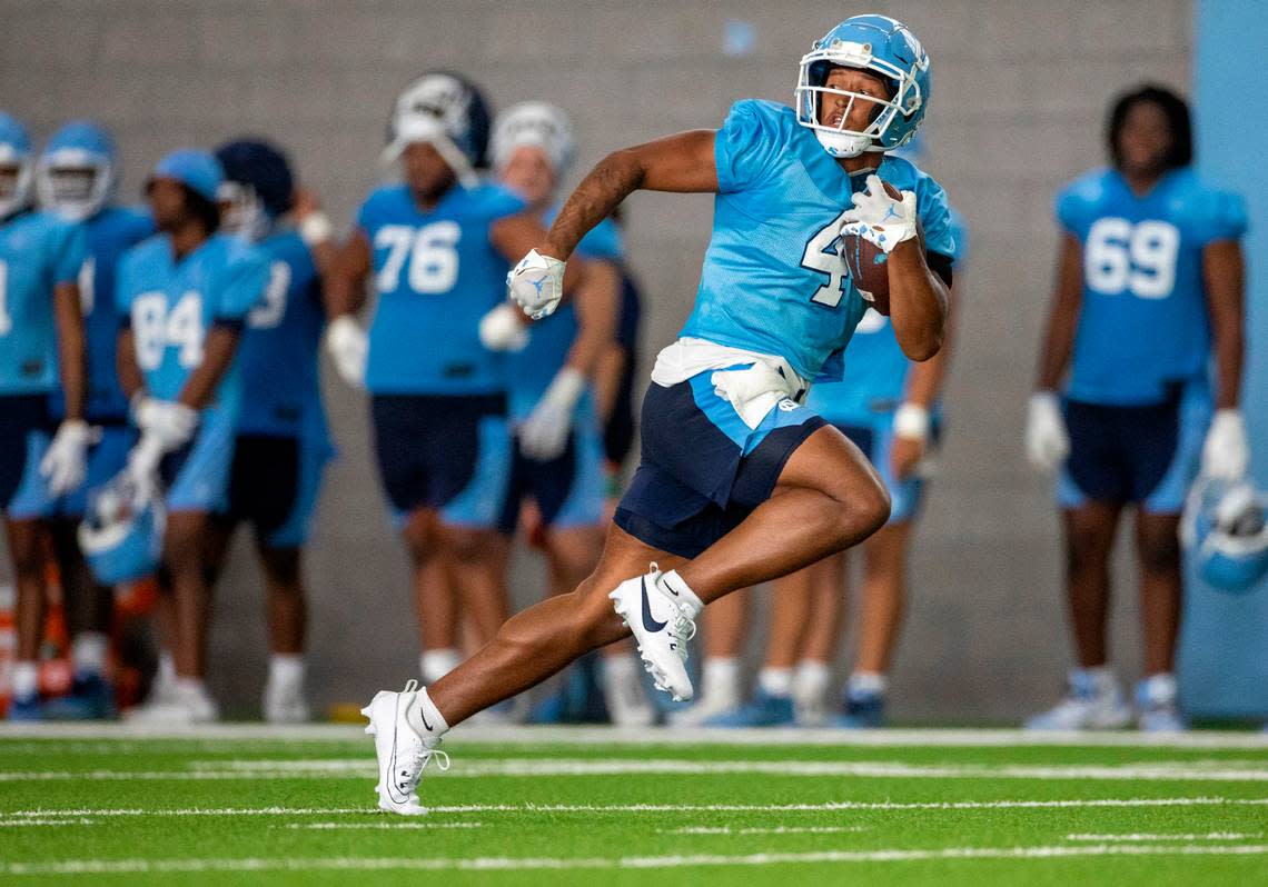 North Carolina running back Caleb Hood (4) breaks open on a long run during the Tar Heels’ first practice of the season on Wednesday, August 2, 2023 in Chapel Hill, N.C.