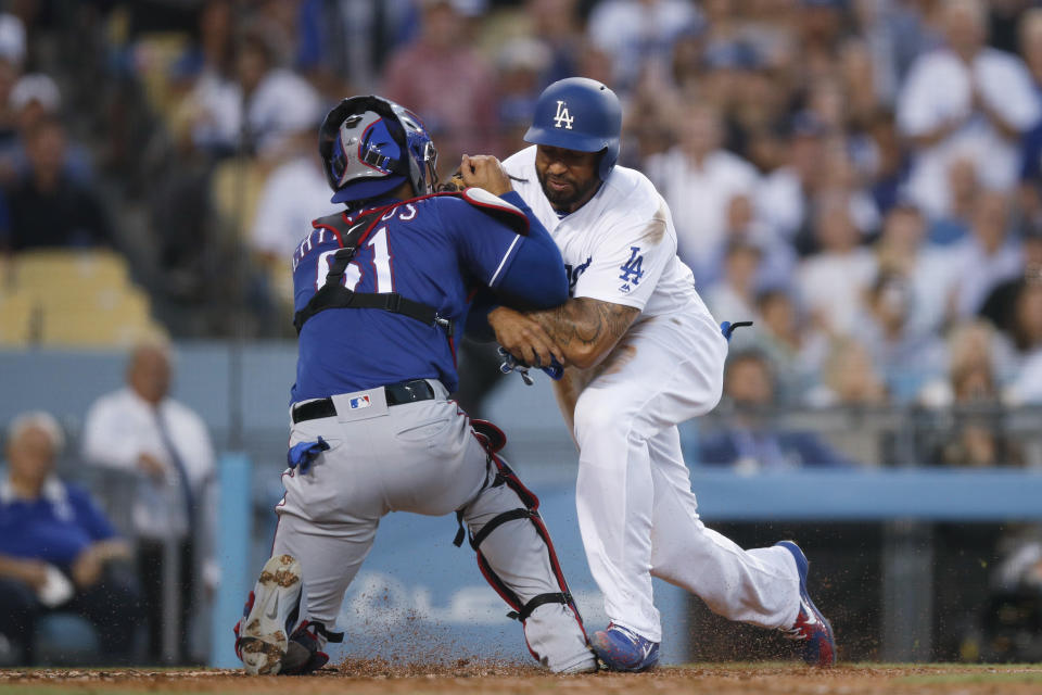 Matt Kemp barreled over Rangers C Robinson Chirinos during a play at the plate Wednesday, prompting both benches to empty at Dodgers stadium. (AP)