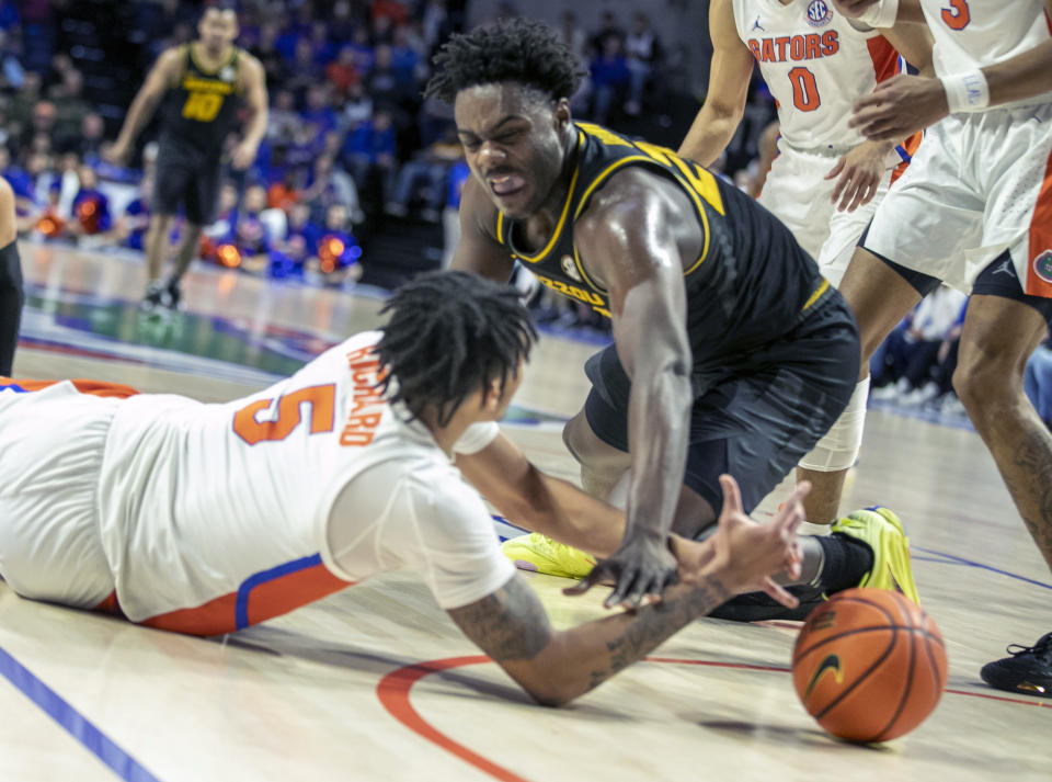 Florida guard Will Richard (5) battles Missouri guard Kobe Brown (24) for the ball during the first half of an NCAA college basketball game Saturday, Jan. 14, 2023, in Gainesville, Fla. (AP Photo/Alan Youngblood)