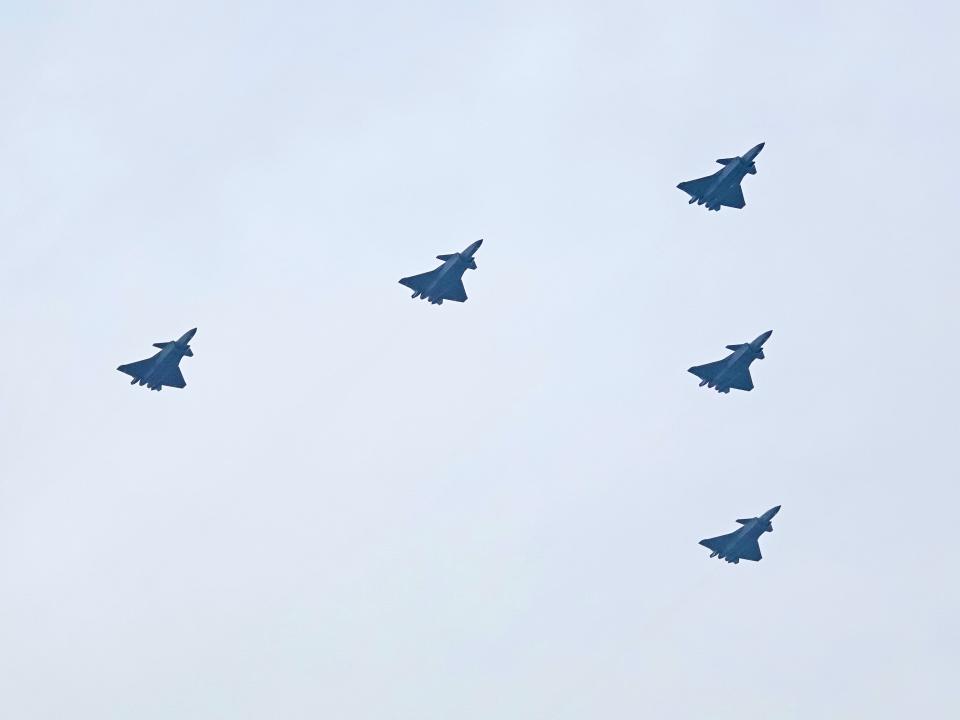J-20 fighter jets fly in formation during a flight performance to celebrate the 100th anniversary of the founding of the Communist Party of China (CPC) in Beijing, China, July 1, 2021.