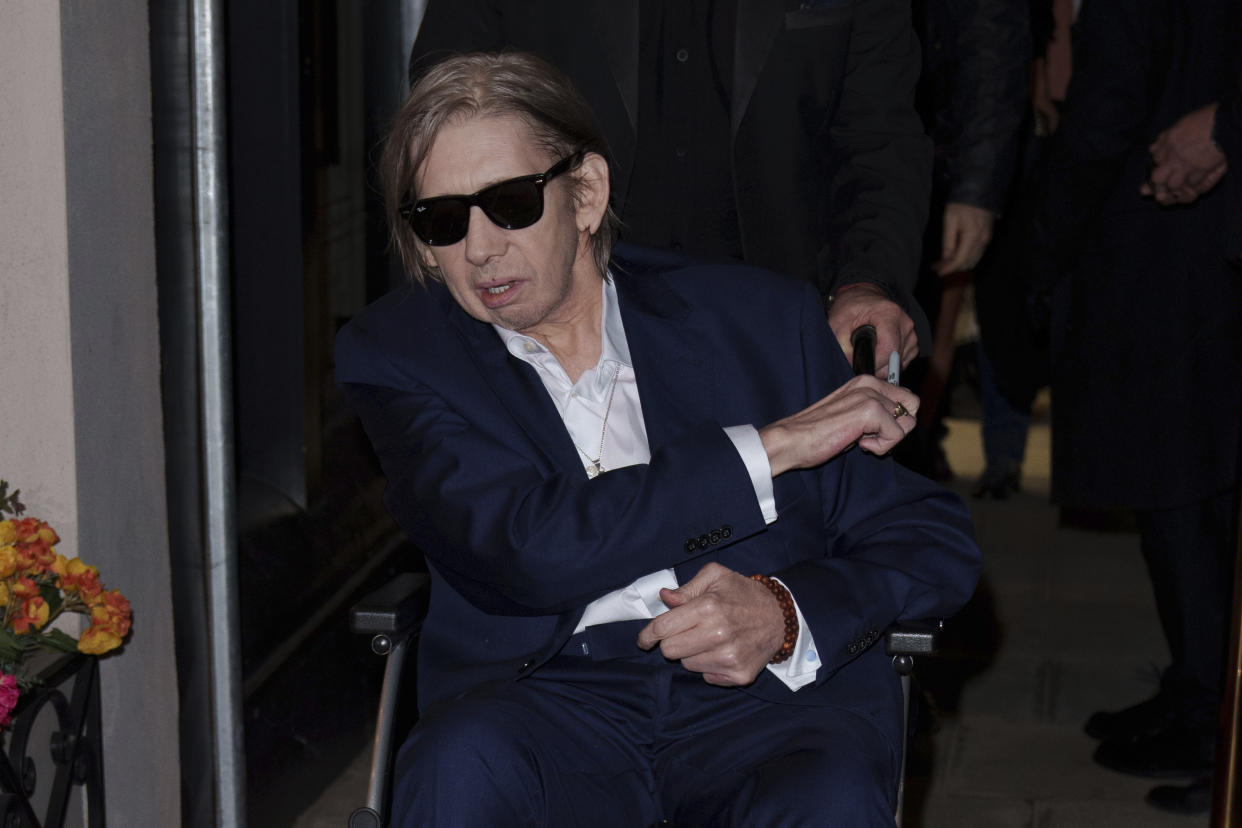 Shane MacGowan poses for photographers upon arrival at the Shane MacGowan, The Eternal Buzz & The Crock of Gold Exhibition in London, Tuesday, Oct. 11, 2022. (Photo by Scott Garfitt/Invision/AP)