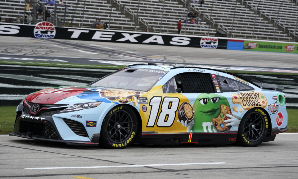 Kyle Busch (18) drives on pit row during qualifying laps for a NASCAR All-Star auto race at Texas Motor Speedway in Fort Worth, Texas, Saturday, May 21, 2022. (AP Photo/Larry Papke)