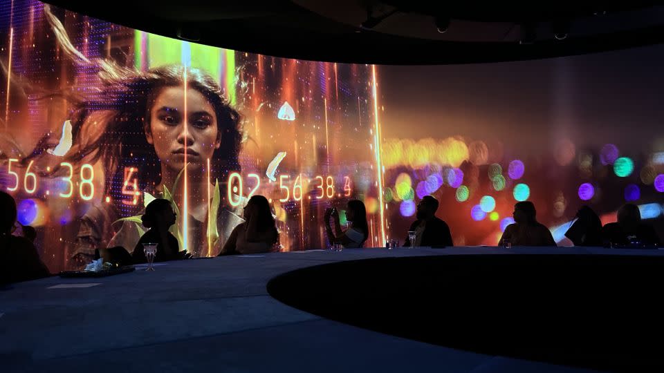 The round room creates a 360-degree immersive experience, with more than 20 projectors showing seamless 3D video graphics. - Rebecca Cairns/CNN