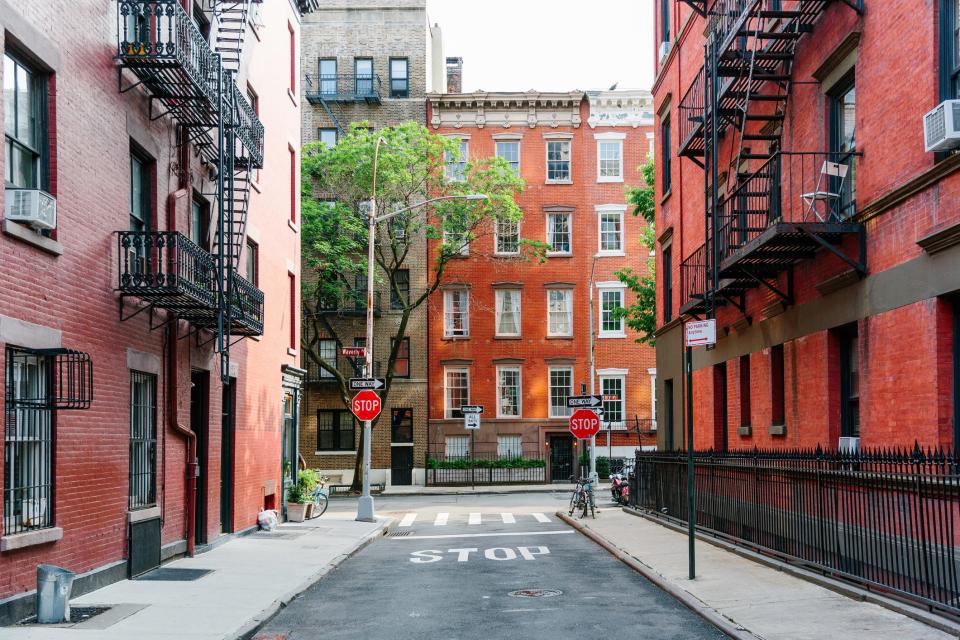 A narrow street leading to a residential building in New York City.