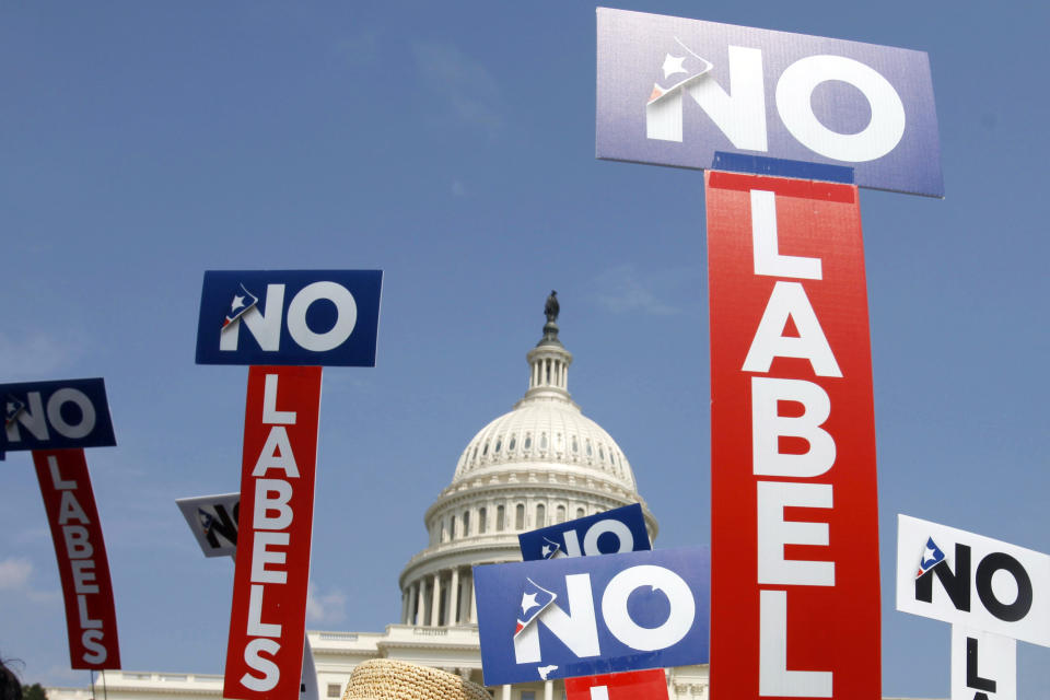 FILE - People with the group No Labels hold signs during a rally on Capitol Hill in Washington, July 13, 2013. The third-party presidential movement No Labels plans to meet on March 8, 2024, amid fierce pressure on donors and potential candidates from Donald Trump critics who fear the deep-pocketed group would help the former president return to the White House. No Labels Chief Strategist Ryan Clancy says no candidates will be selected at the meeting. (AP Photo/Jacquelyn Martin, File)