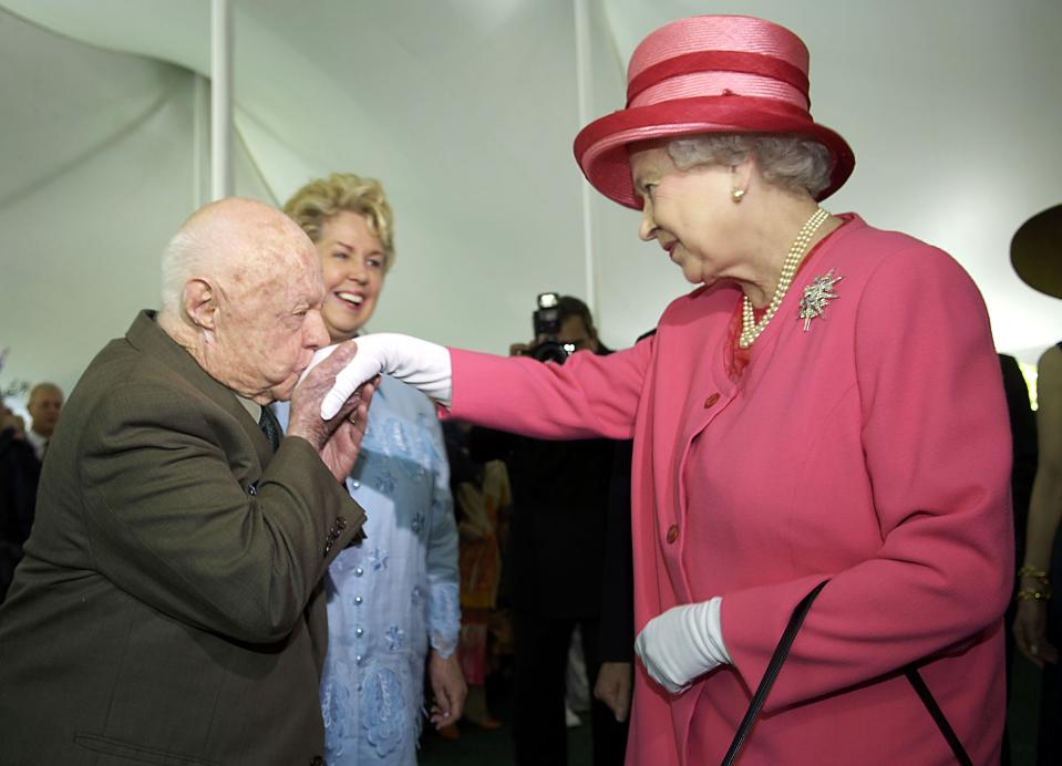 Actor Mickey Rooney kisses the hand of Britain's Queen Elizabeth during a garden party celebrating her state visit to the U.S. at the British Embassy in Washington in this May 7, 2007 file photo. Rooney, the pint-sized screen dynamo of the 1930s and 1940s best known for his boy-next-door role in the Andy Hardy movies, died on April 6, 2014 at 93, the TMZ celebrity website reported. It did not give a cause of death and a spokesman was not immediately available for comment. REUTERS/Jonathan Ernst/Files (UNITED STATES - Tags: ROYALS ENTERTAINMENT OBITUARY)