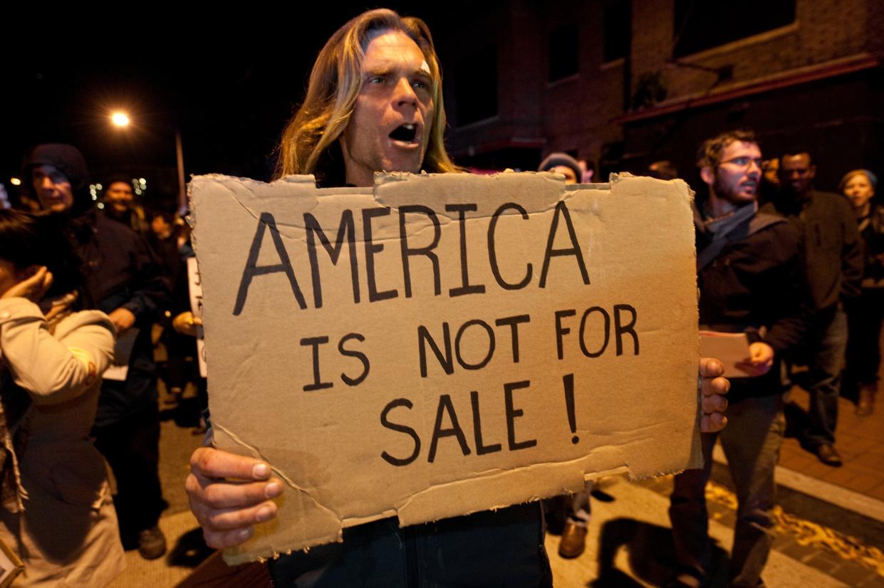 <p>Congress has been urged to act to stop billionaire donors after new analysis found that 12 people contributed $3.4billion to federal campaigns in the last ten years. Pictured a protestor from the Occupy DC march in Washington against the billionaire conservative donor Koch brothers and Americans for Prosperity in 2011</p> (Getty)