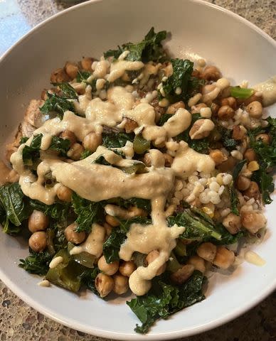 <p>Dana Ingemann</p> A creation from my prepped food: couscous, roasted chickpeas, roasted kale, onions, peppers, golden raisins, and a lemon-tahini dressing.